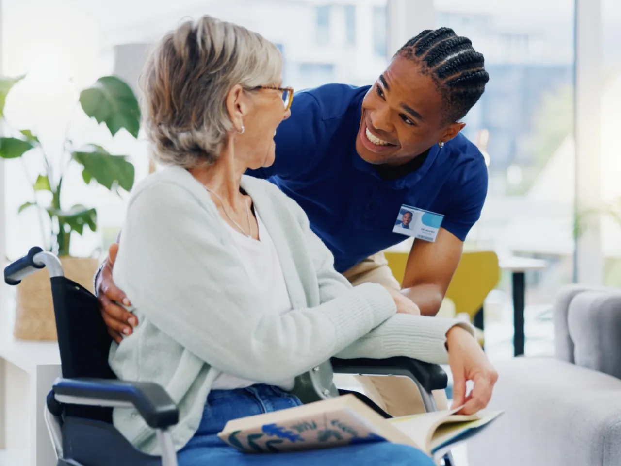 A caregiver brushing an older woman's hair