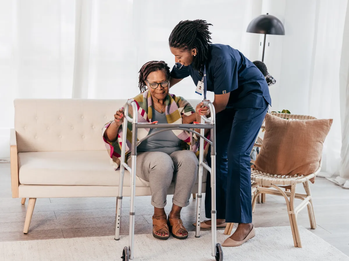 A caregiver sharing a laugh with an older woman at home